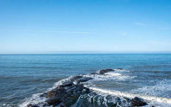 Vedro plavo nebo iznad oceana s čistim horizontom i svijetlim pozadinama.