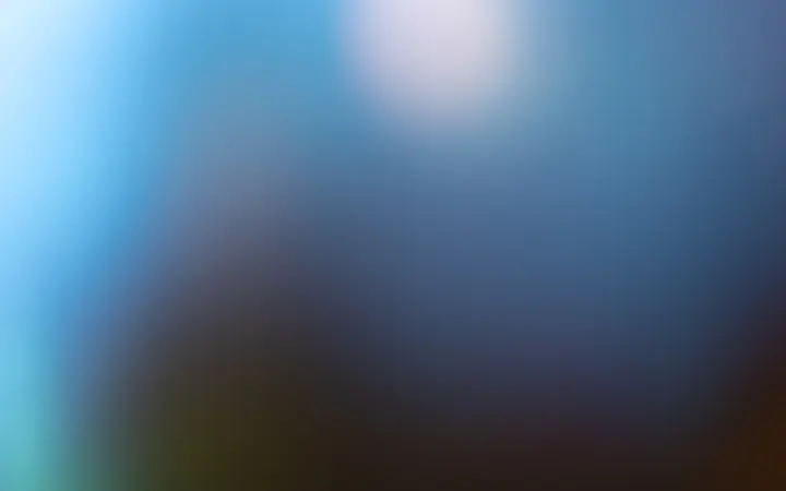 Blago zamućeni plavi bokeh krugovi stvaraju umirujući i mekani vizualni dojam.