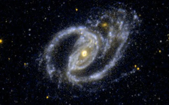 Interakcija barred spiralne galaksije NGC 1097 i malog eliptičnog pratitelja u ultraljubičastom svjetlu.